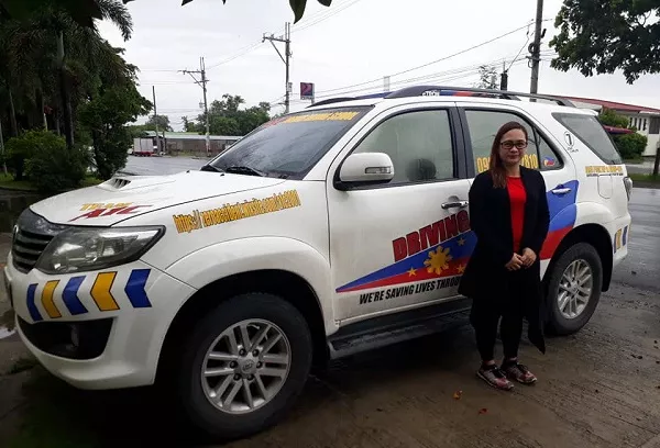 A happy student driver of A1C driving school A1C Toyota Innova training vehicle