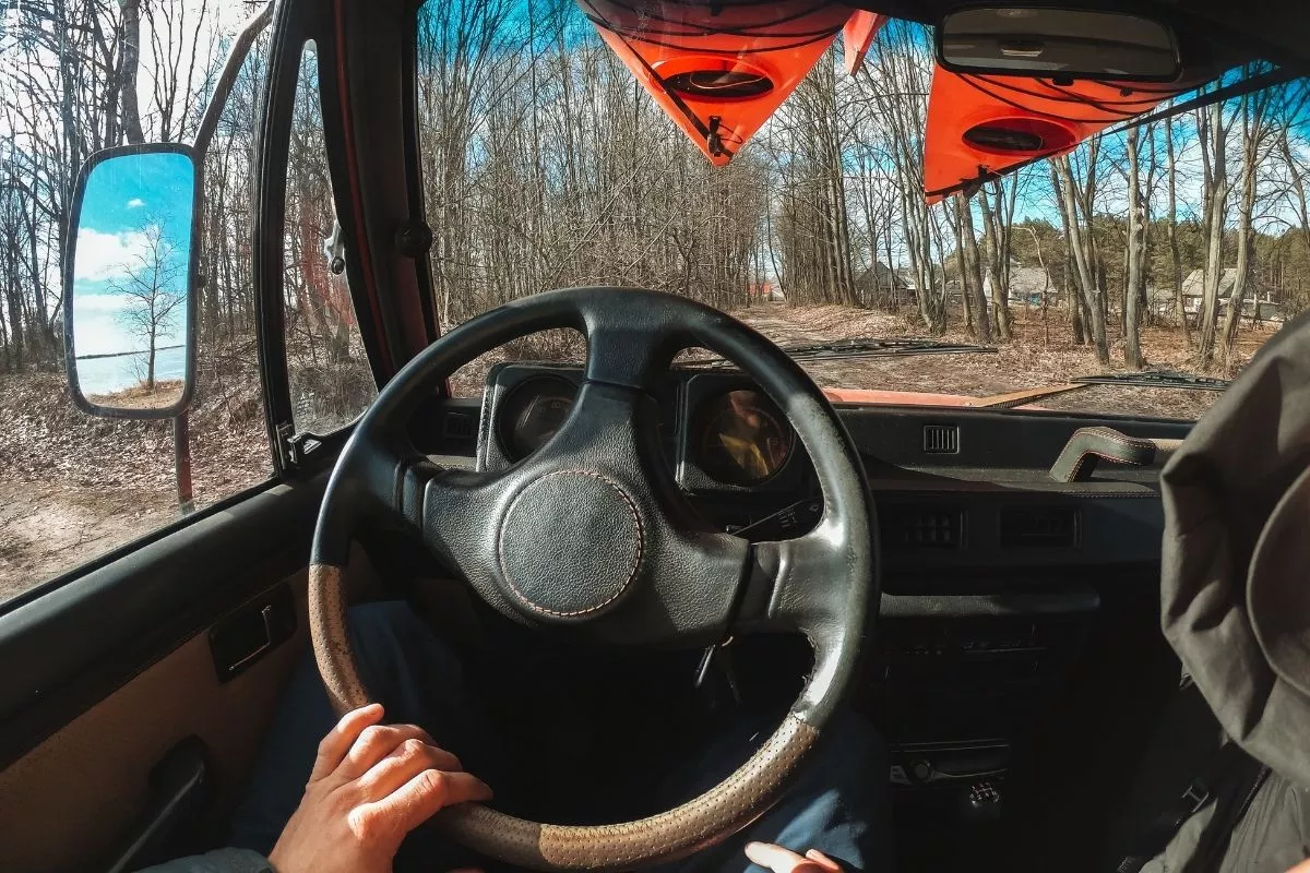 A picture of a man driving an SUV