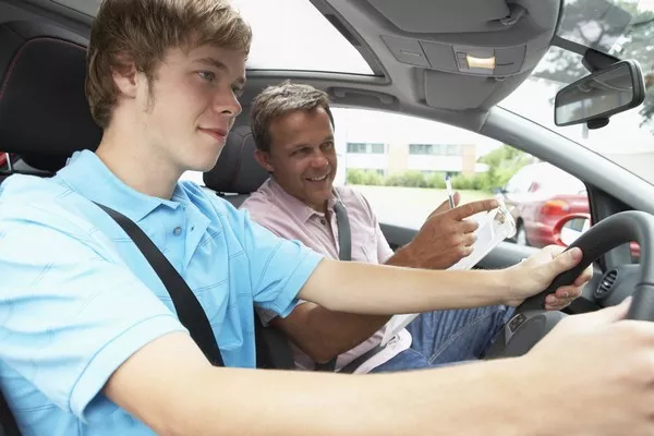 a man teaching a boy how to drive