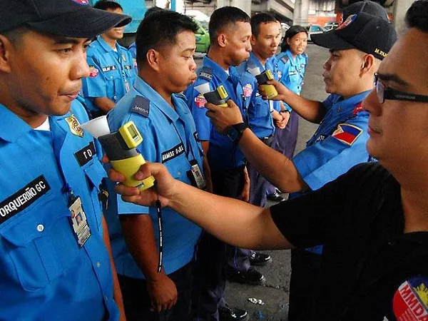 The law enforcement officers are equipped with breathalyzers that measure the sobriety of drivers. Officers testing the breath analyzers