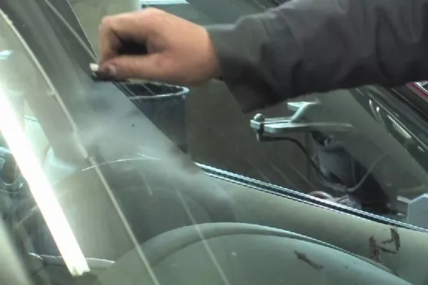 Man scratching the car window