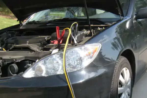 car with jumper connected to its batteries