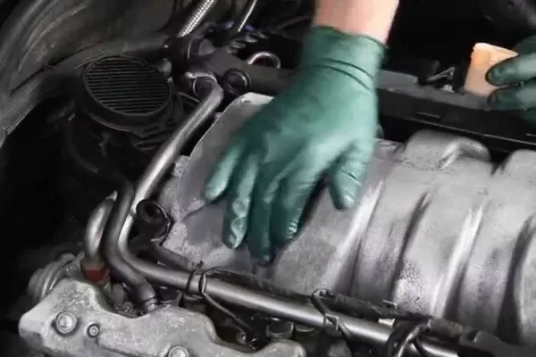 man cleaning the engine parts
