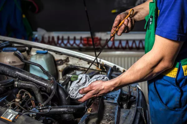 Man checking the car's engine oil