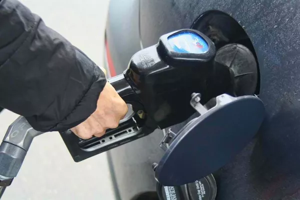 Vehicle owners should always keep at least half a tank of fuel so the vehicle is always ready and safe for use car getting gas refill