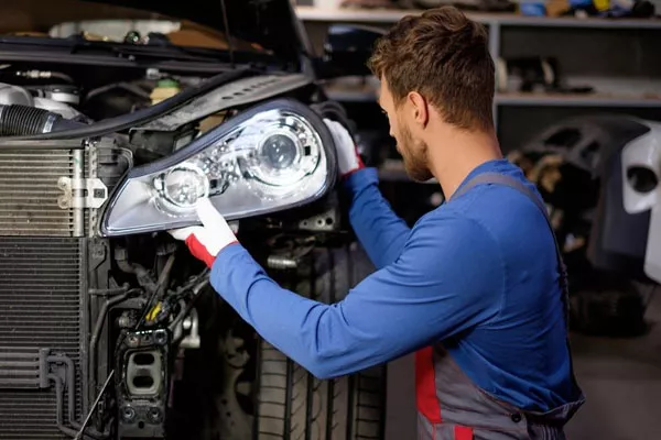 mechanic checking headlights
