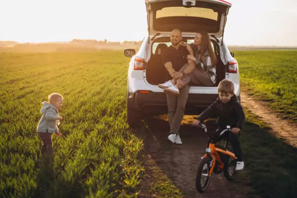 A picture of a family with their car