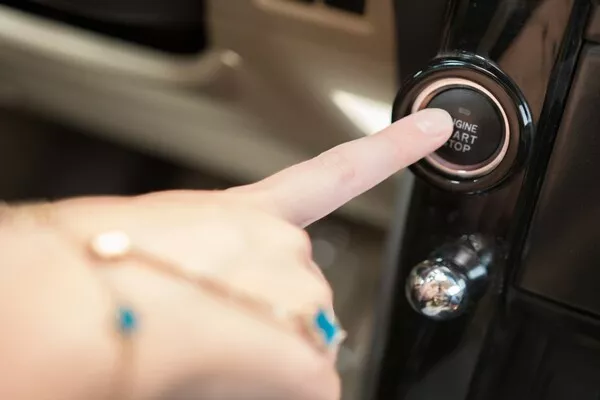 Driver pressing the engine start button