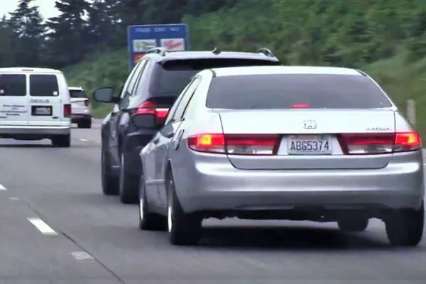 Gray car tailgating the black car