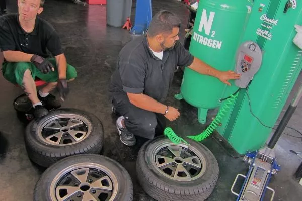 A picture of tire specialists filling tires with nitrogen.
