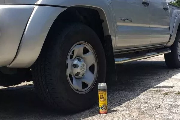 FIx-a-flat beside a car