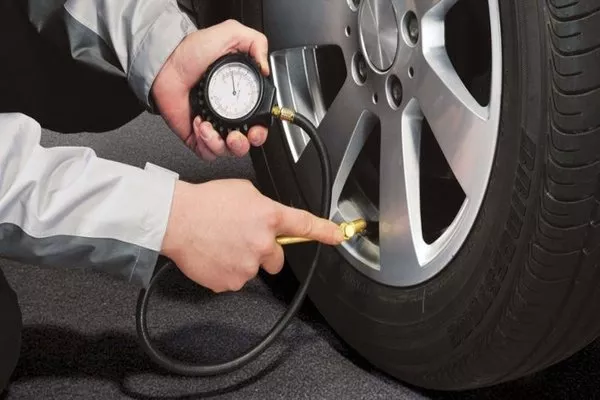 Man checking tire pressure