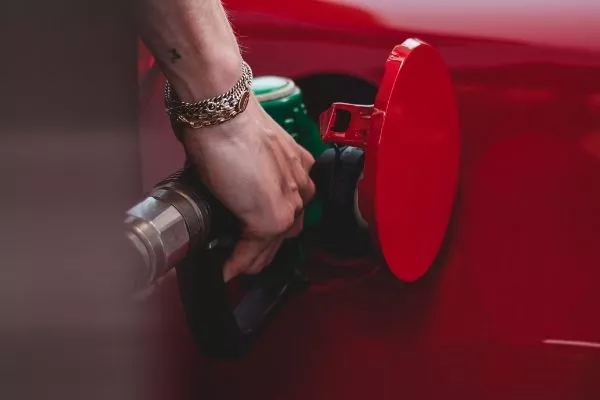 Filling up a red car
