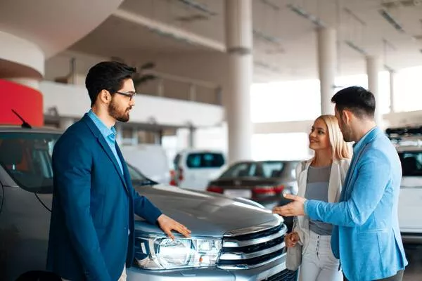 Man talking to a car salesperson