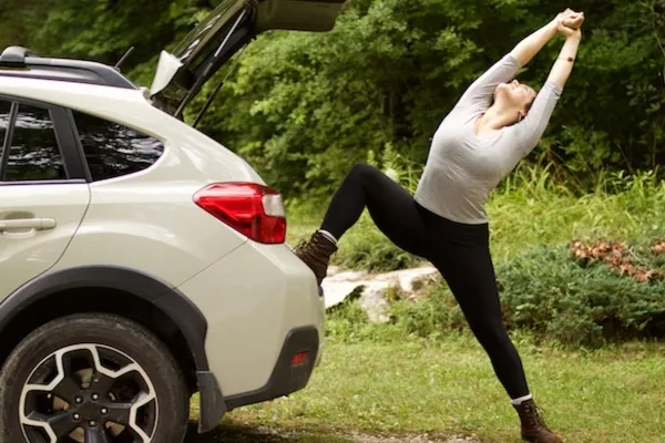 Woman stretching outside the car