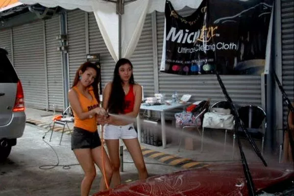 girls powerwashing car