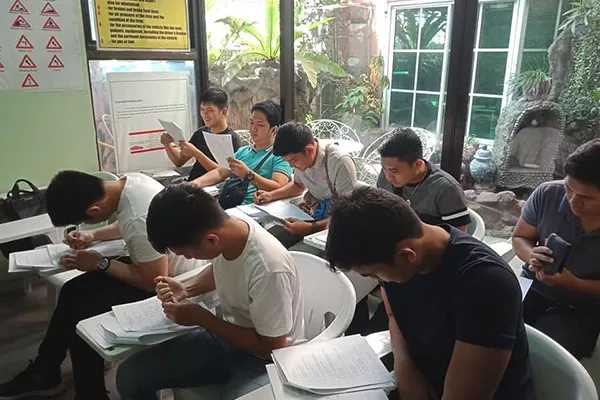 Several student driver's undergoing a written exam in Good Sign Tutorial Driving Academy Students at Good Sign Tutorial Driving Academy