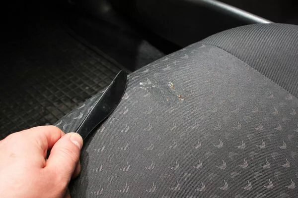 Scraping off residue in the car seat
