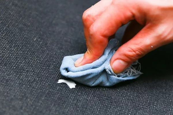 Man removing gum on the car seat