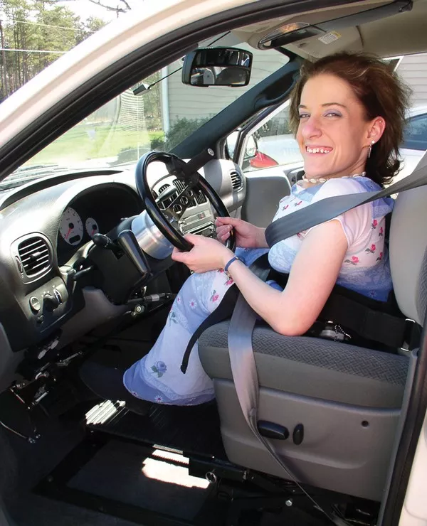 Woman with disability in a modified driver's seat