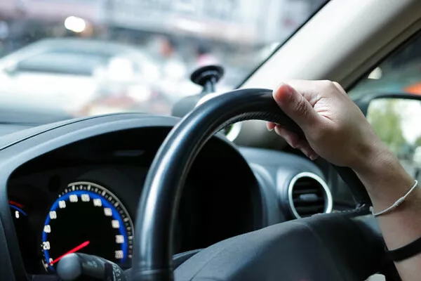 If you notice that your car’s steering wheel feels unstable or a little loose, it can be because of a poor wheel alignment Man driving