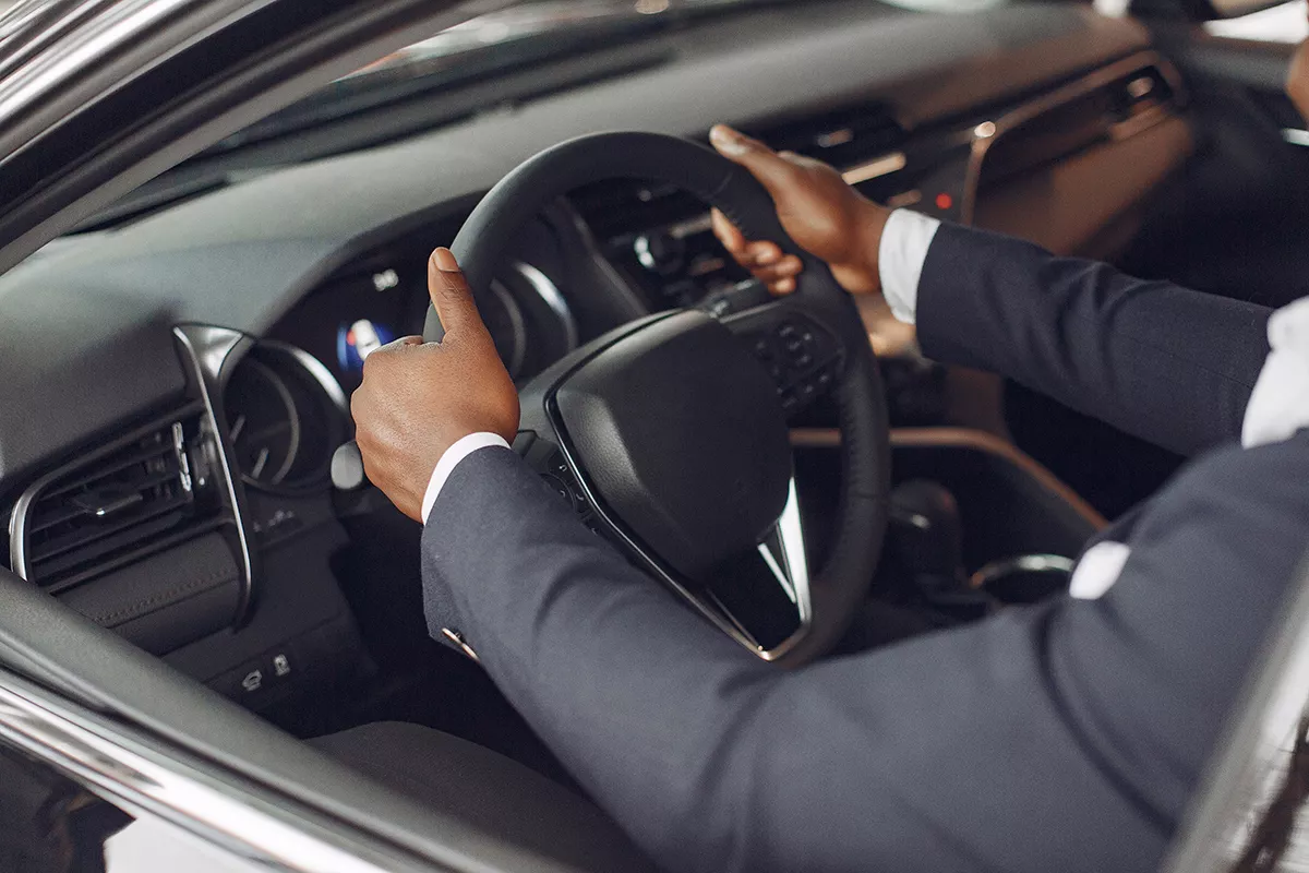 A picture of a man enjoying his new car