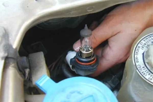 Man changing headlight bulbs