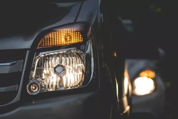 A vehicle illuminating its headlights