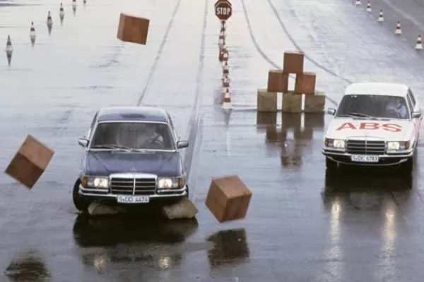 With time, anti-lock brakes were perfected into the ABS we know today Two cars in the slippery road