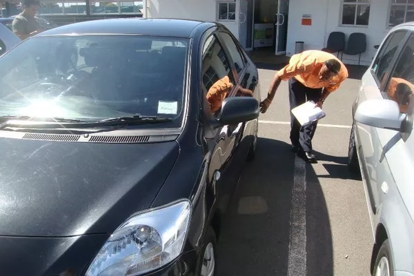 man inspecting a car