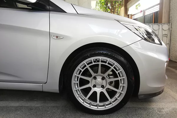 A picture of a Hyundai Accent modified with Rota Recces.