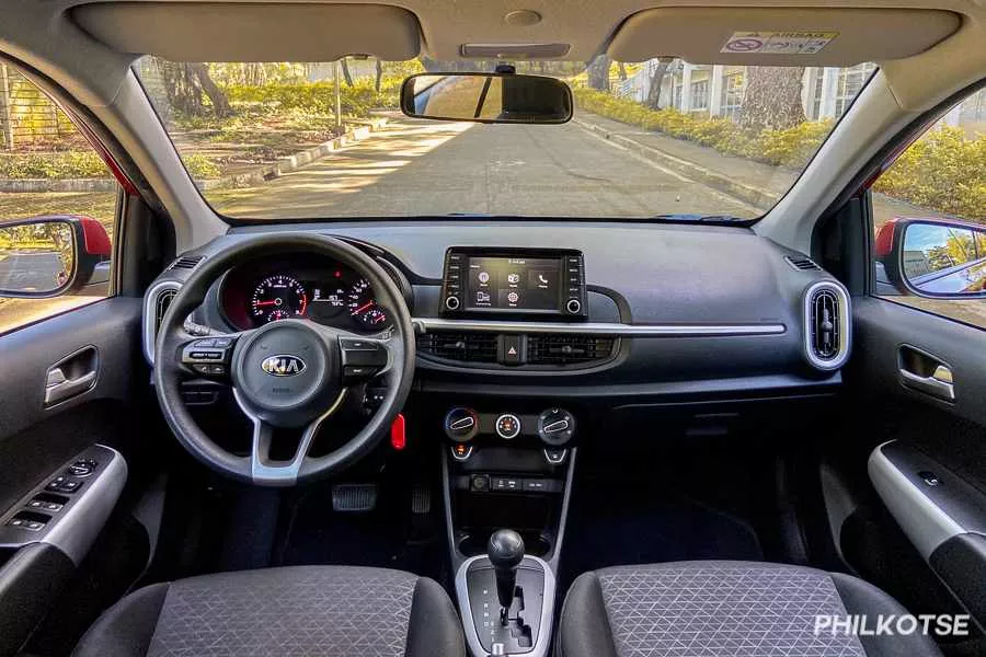A picture of the Kia Picanto's dashboard, steering wheel, and center console