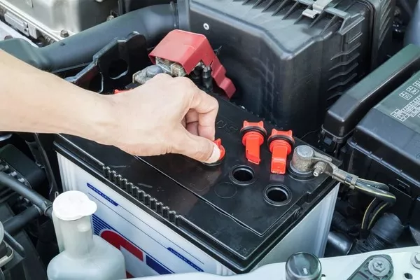 Man checking car battery