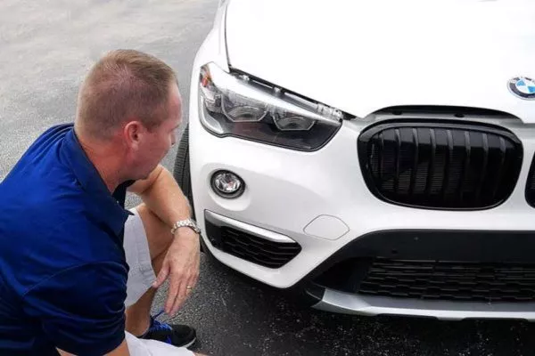 Man inspecting the car