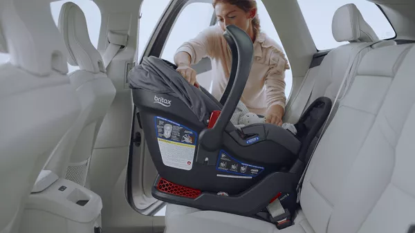 Woman putting the baby car seat