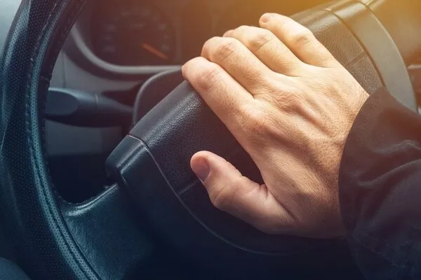 Man pressing the car horn