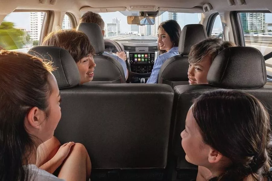 A picture of a family riding an SUV
