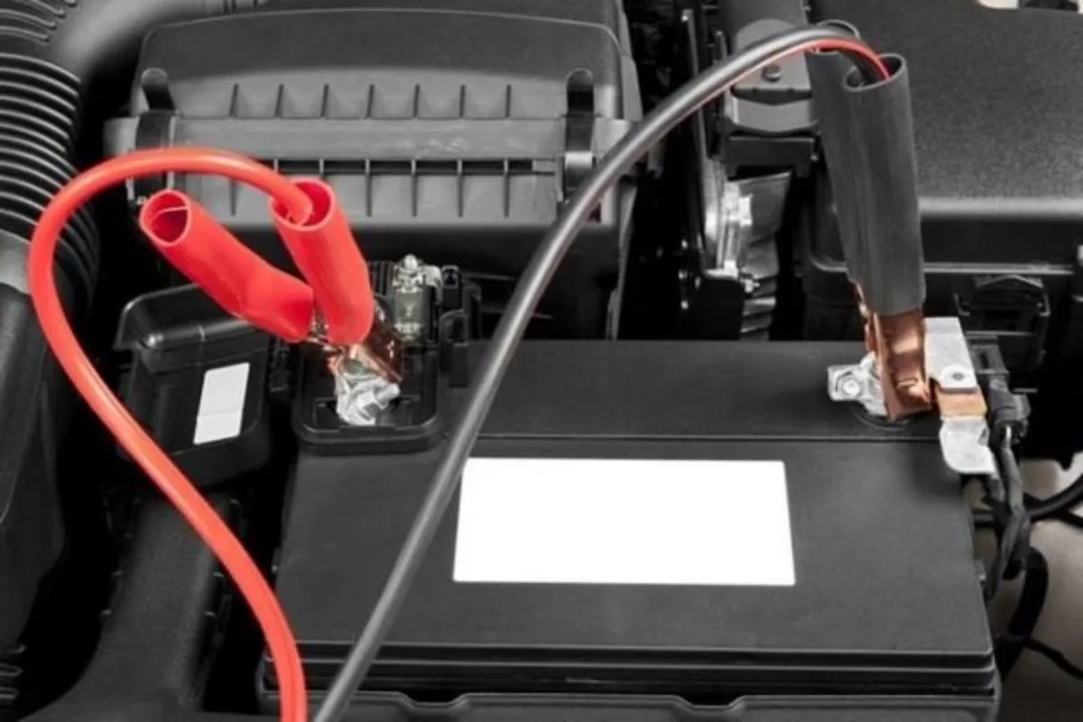 A picture of a car battery with jumper cables