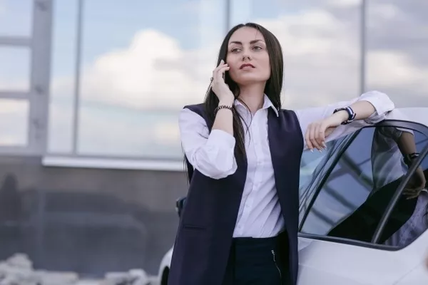 woman leaning on the car