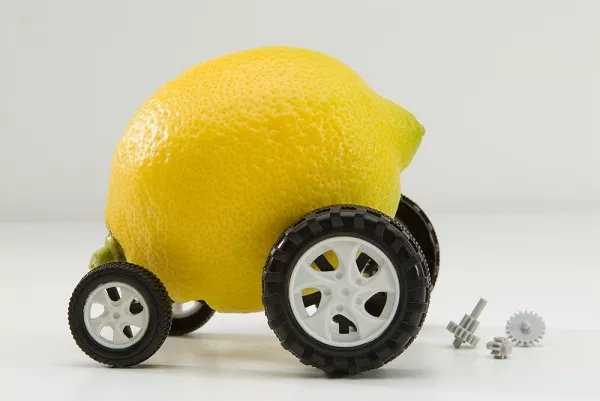 Explanation of Lemon law meaning by a car made from lemon