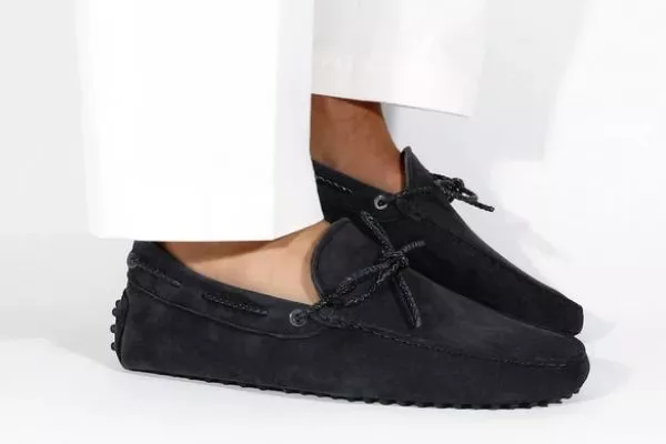 A picture of a person wearing dark colored loafers