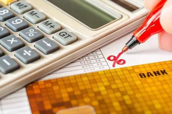 calculator and a red pen 