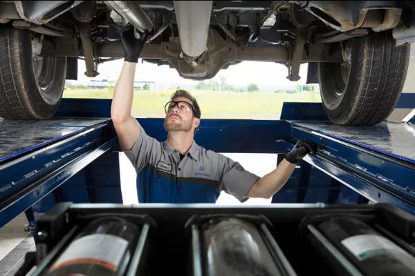 man checking the parts under the car