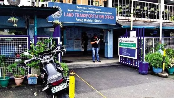 An LTO office with a man standing on the entrance