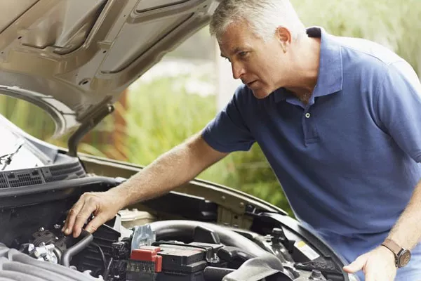 man checking engine
