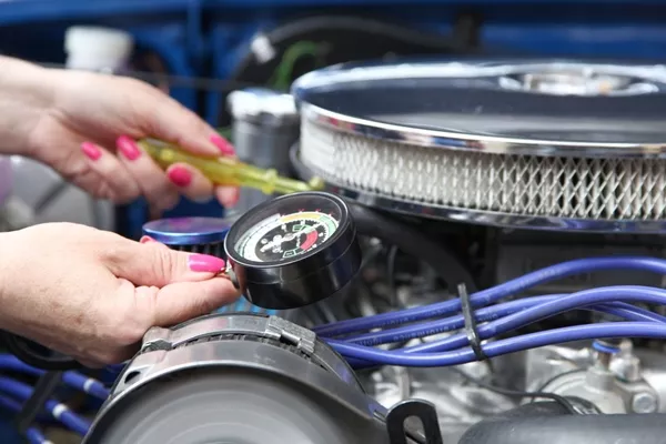 man checking for oil leaks