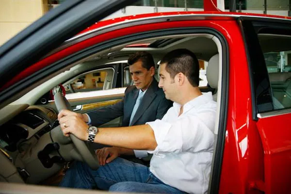 Take a good feel as a driver by positioning yourself in the driver's seat man on the driver's seat