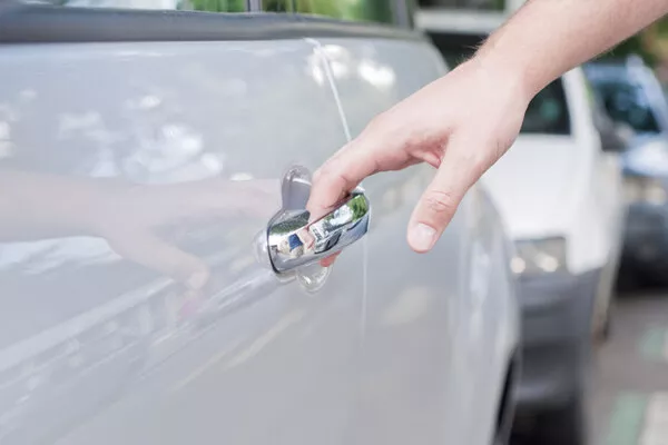 Man pulling the door handle