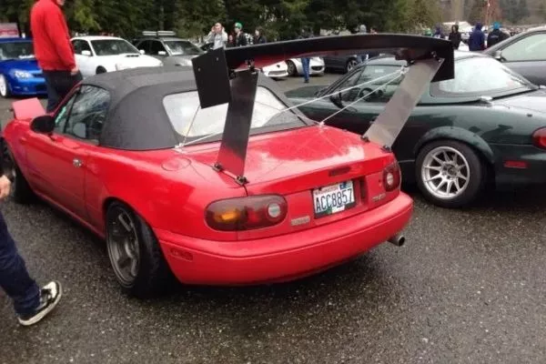 A picture of a Miata with a huge wing