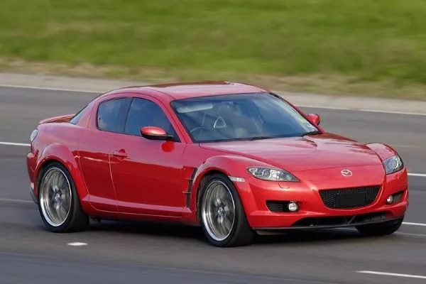 A picture of a Mazda RX8 on a highway.